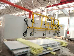 90 degree tilting vacuum lifter for refrigerated truck body assembly