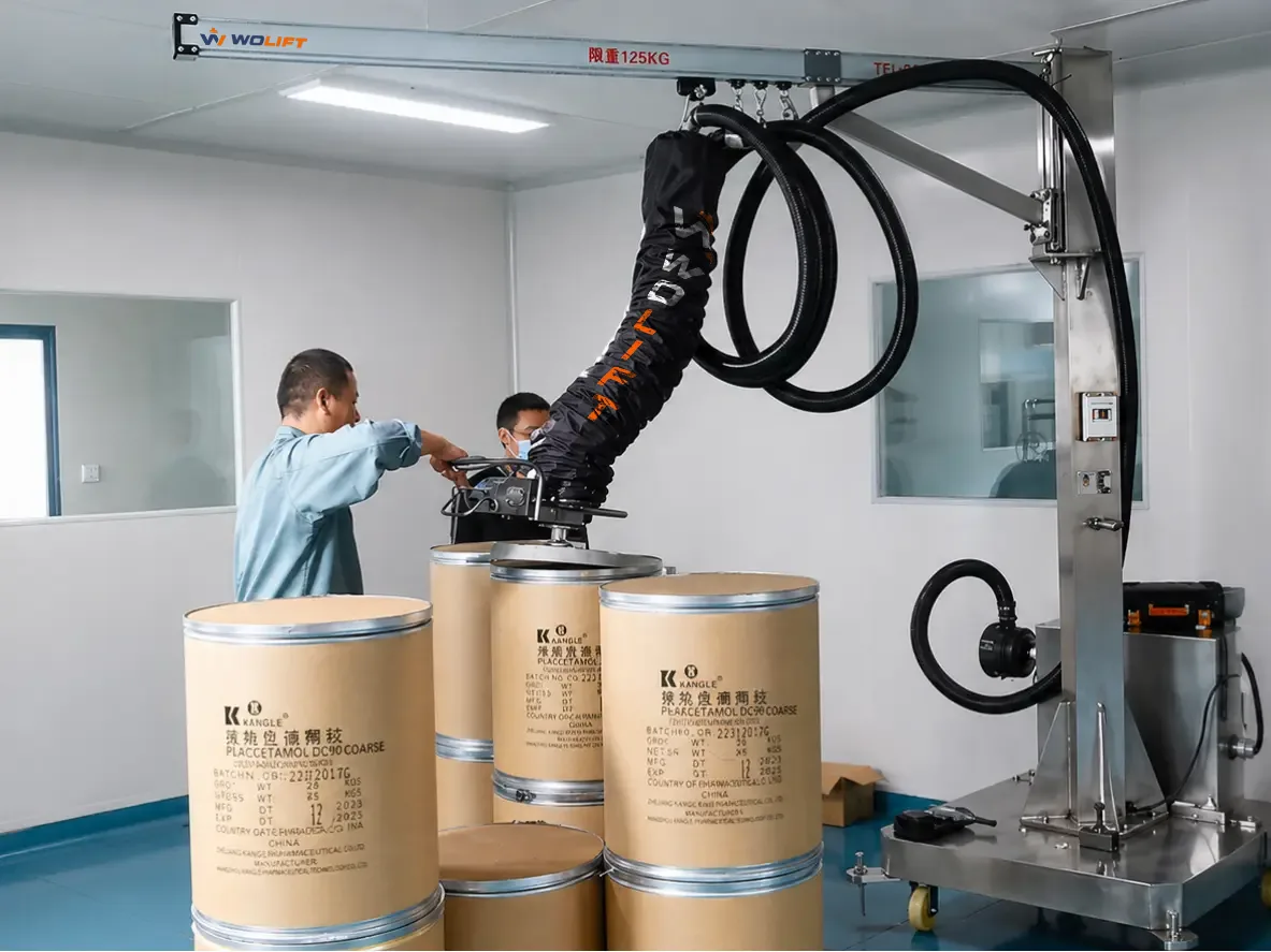 WOLIFT vacuum tube lifter gripping a 50 kg drum during vertical pallet handling