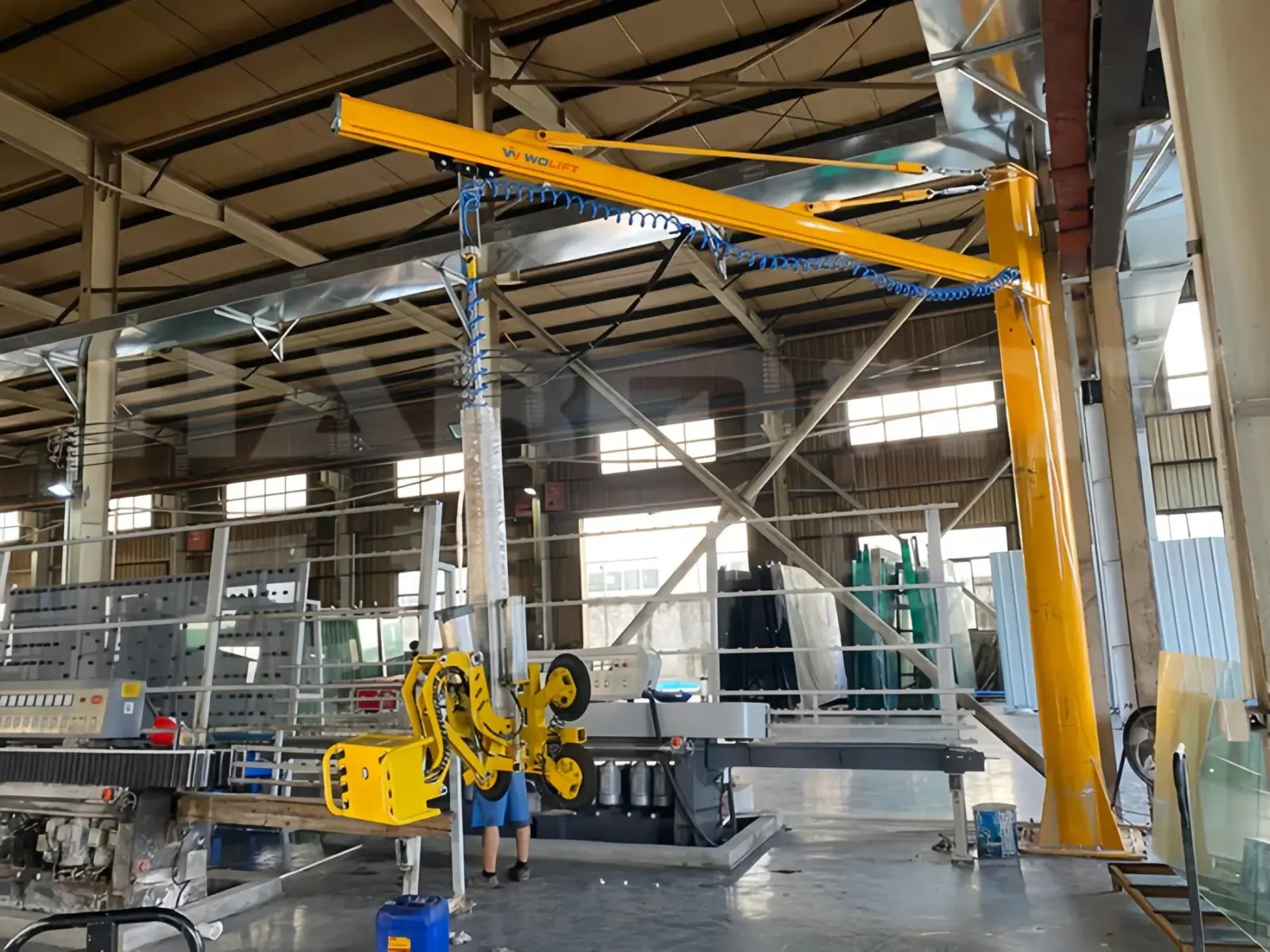 WOLIFT pneumatic glass vacuum lifter loading glass sheets in a processing plant
